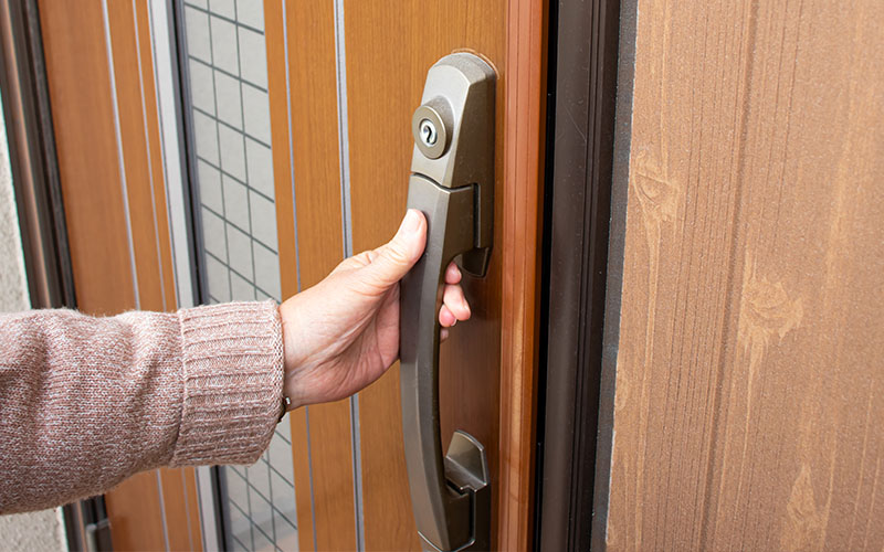 Home Sitter Checking Door Lock